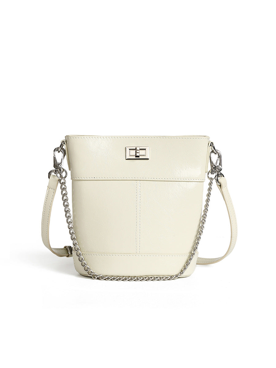 White handbag with a chain detail on a white background