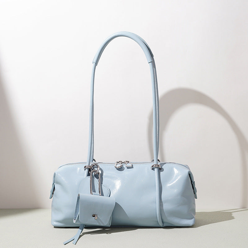 Light blue handbag with a strap on a light background