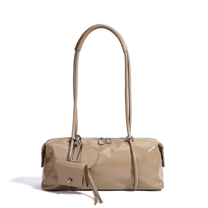 Beige handbag with a matching pouch on a white background