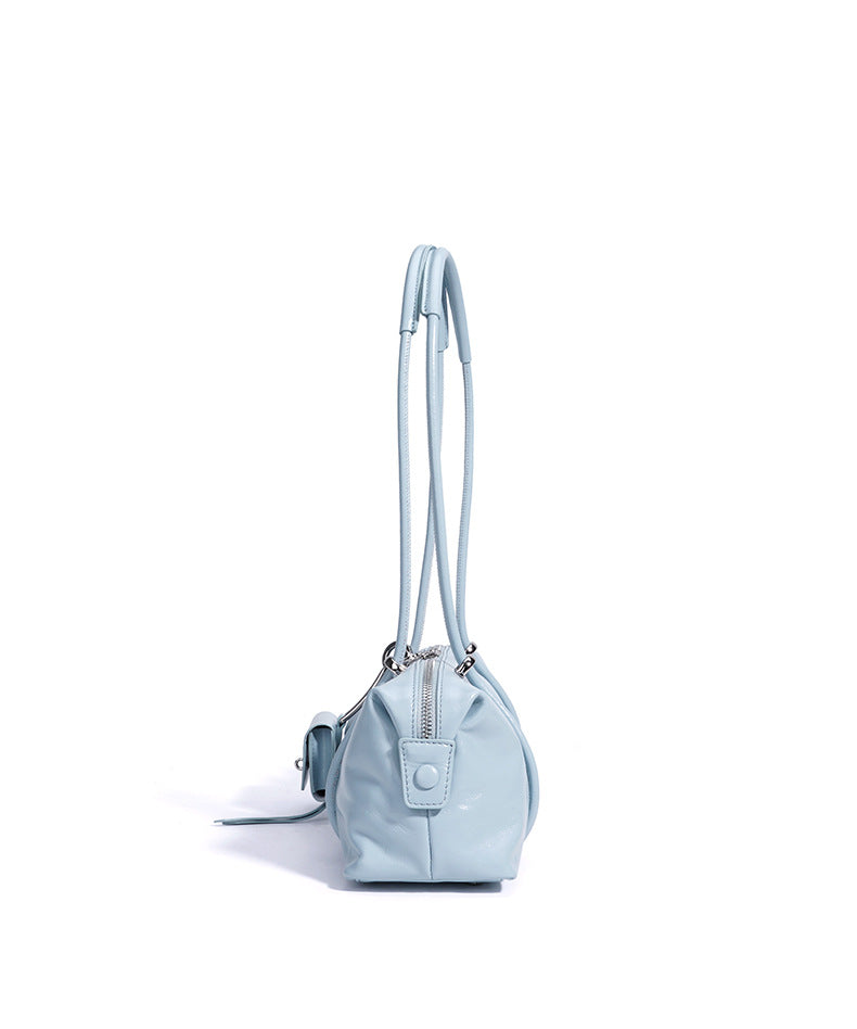 Light blue handbag with a strap on a white background