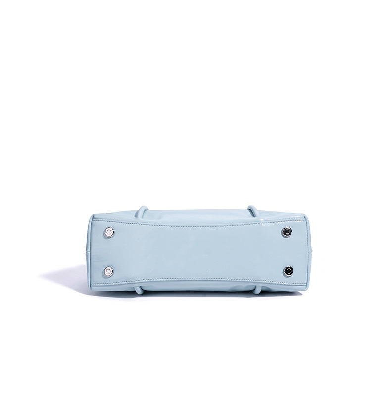 Light blue handbag with silver hardware on a white background