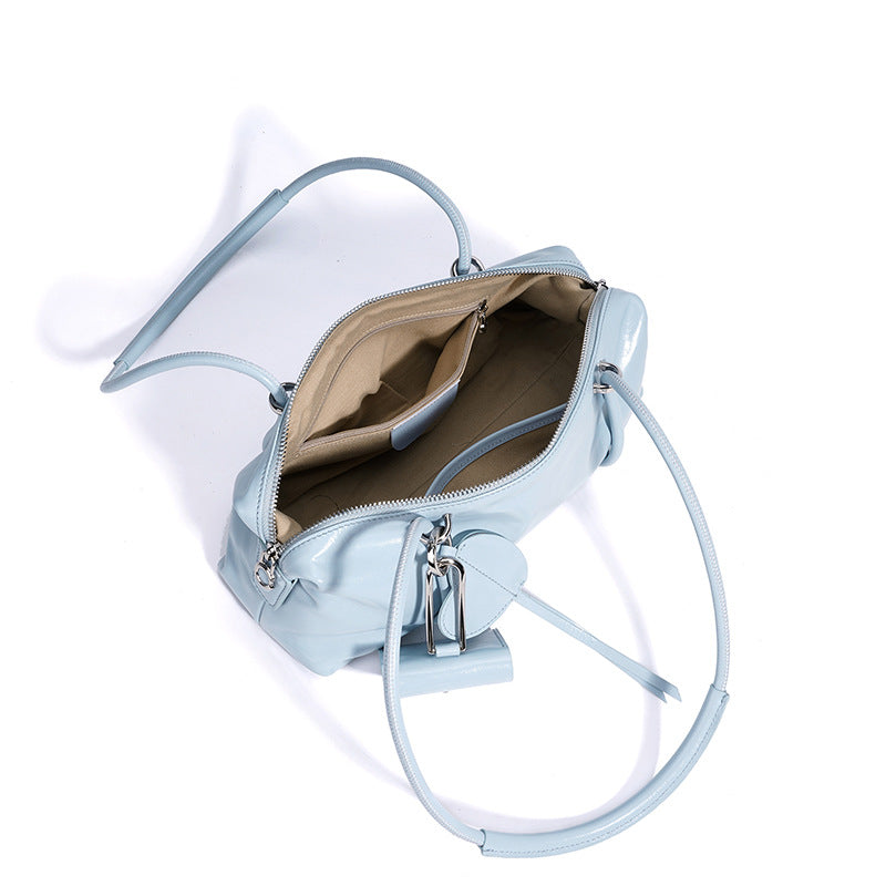 Light blue handbag with a keychain on a white background