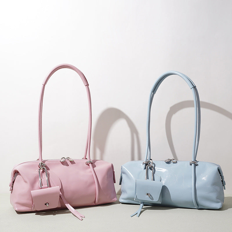 Pink and light blue handbags on a light background