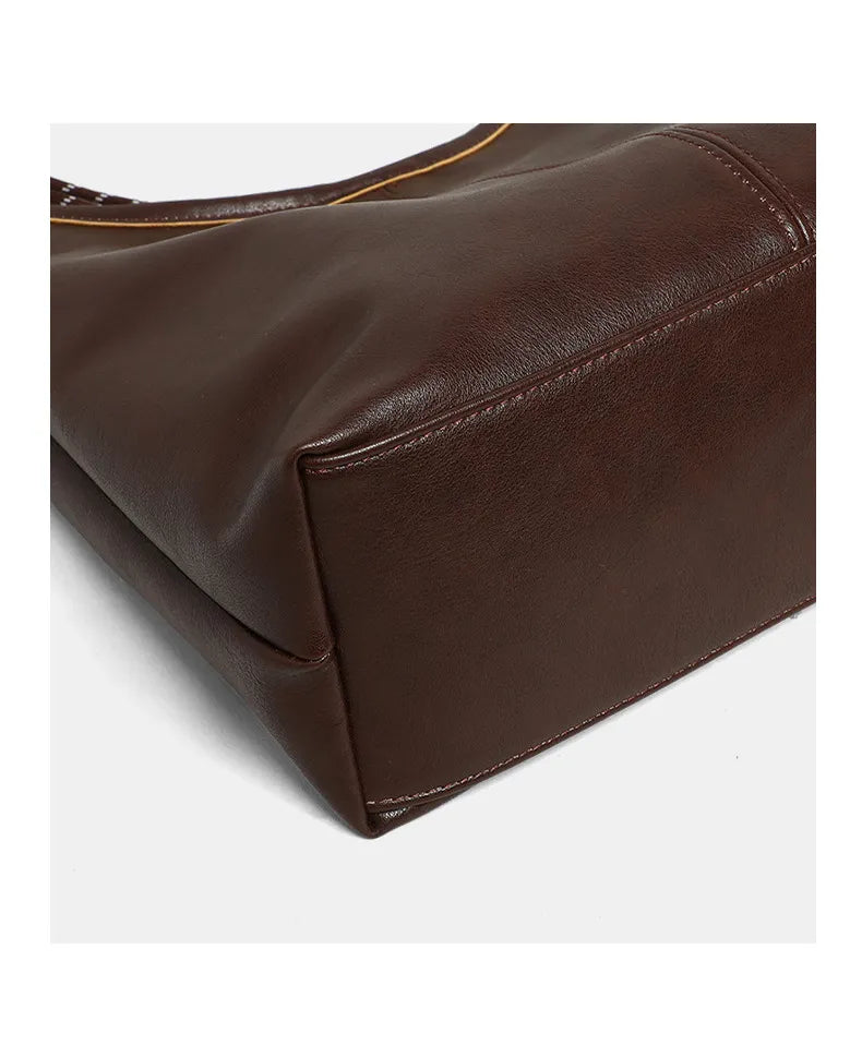 Close-up of a brown leather bag on a white background