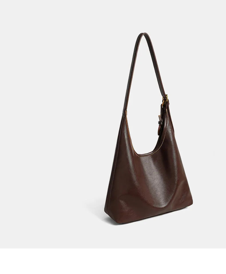 Brown leather handbag on a light gray background