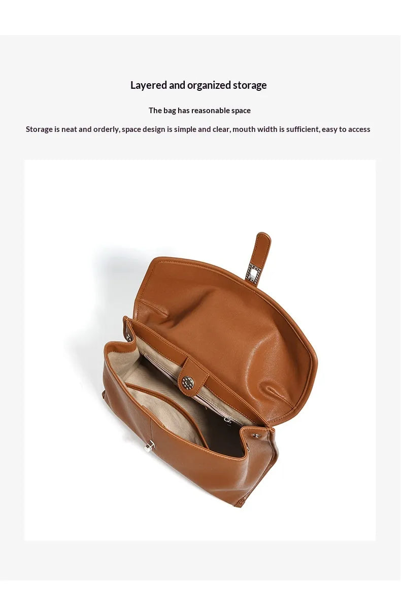 Brown leather bag with open interior on a white background