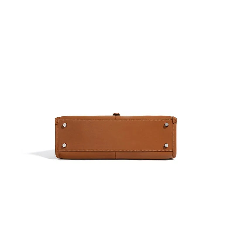 Brown leather bag with silver studs on a white background