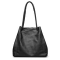 Black leather handbag on a white background