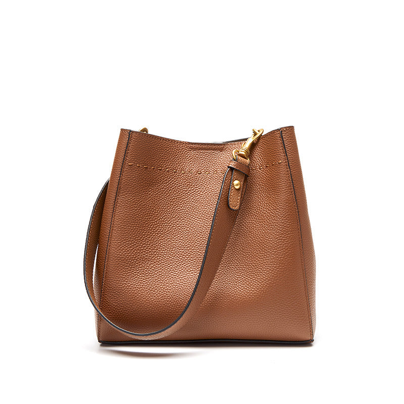 Brown leather handbag with a gold zipper on a white background