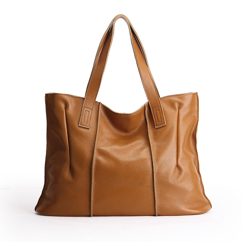 Brown leather tote bag on a white background