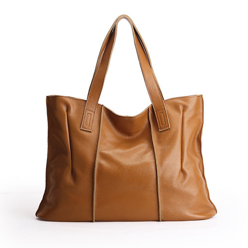 Brown leather tote bag on a white background