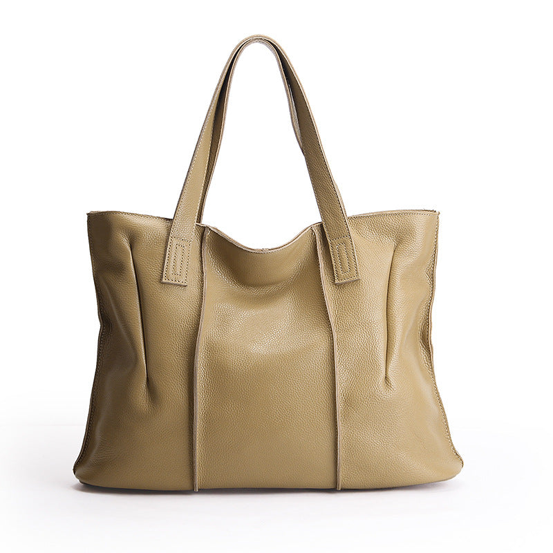 Beige leather tote bag on a white background