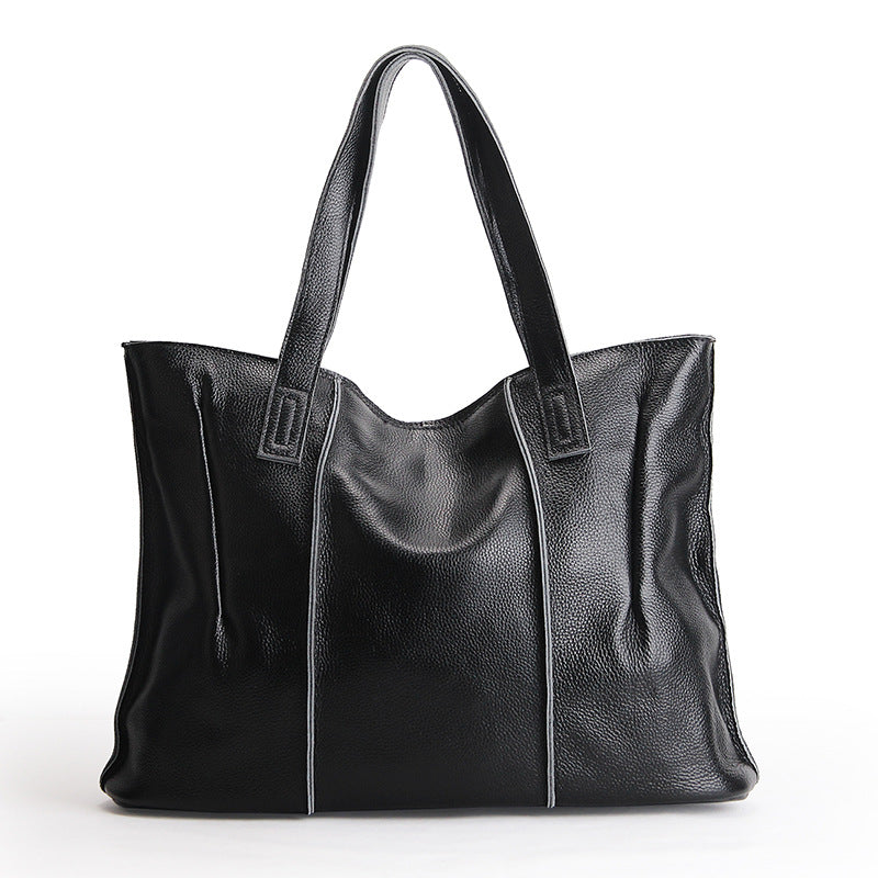 Black leather tote bag on a white background
