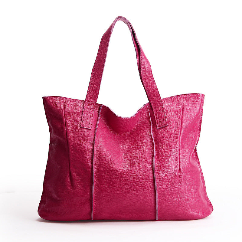 Pink leather tote bag on a white background