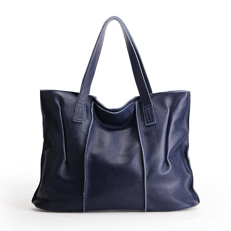 Blue leather tote bag on a white background