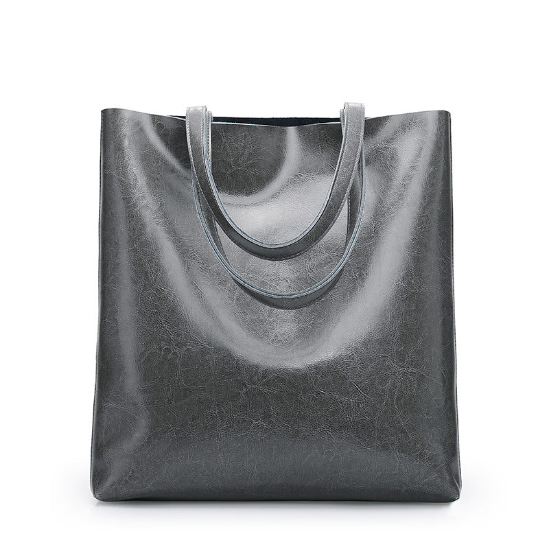 Black leather tote bag on a white background