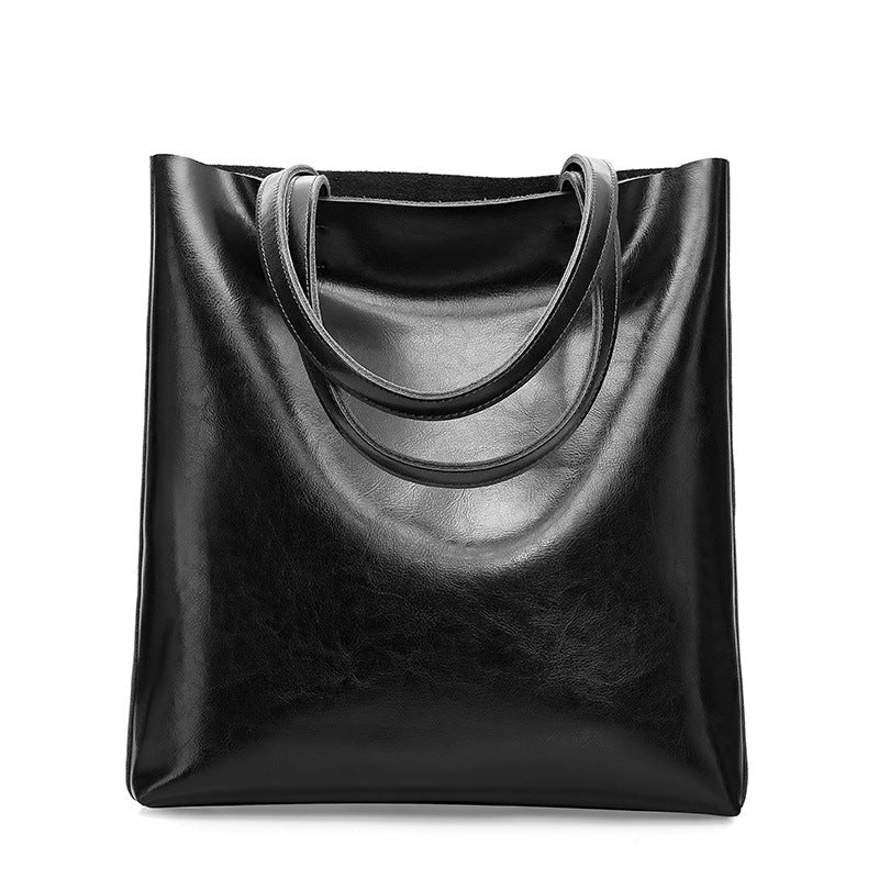 Black leather tote bag on a white background