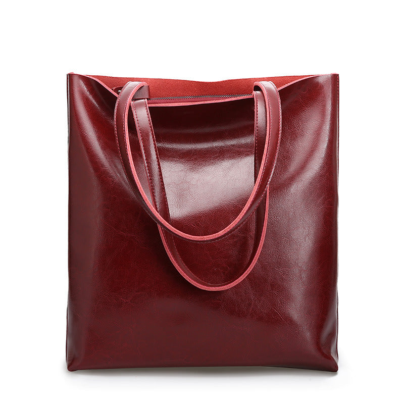 Red leather tote bag on a white background