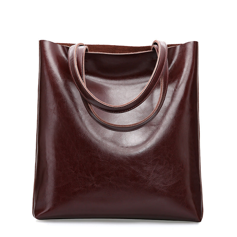 Brown leather tote bag on a white background
