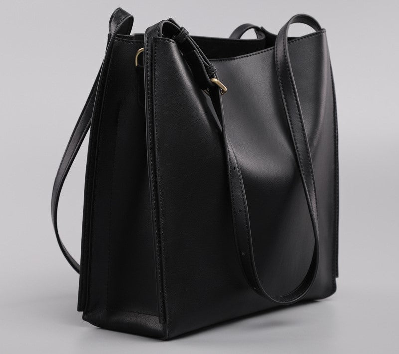adjustable shoulder strap detail on women's black commuter tote bag
