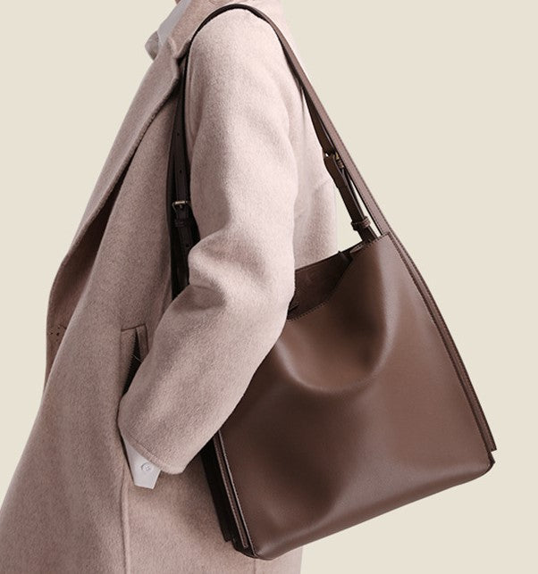 structured women's black leather commuter tote bag side angle view
