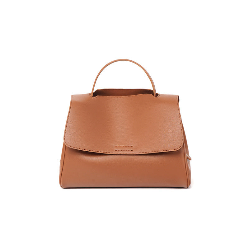 Woman wearing a minimalist vegan leather shoulder bag outdoors in Canada by AETHEL